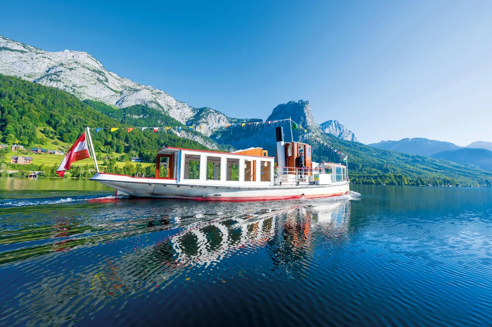 Traditional passenger boat on an Alpine lake.